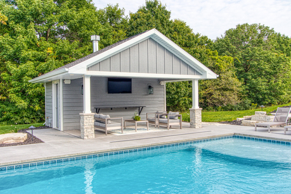 Example of a mid-sized backyard concrete and rectangular pool house design