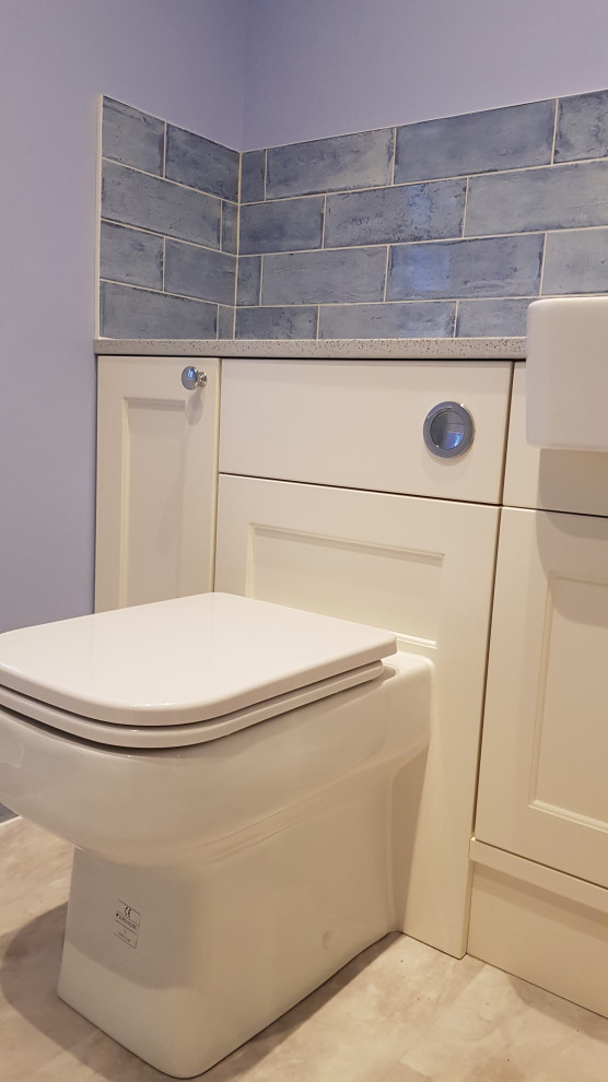 Small contemporary 3/4 bathroom in Kent with shaker cabinets, white cabinets, an open shower, a one-piece toilet, blue tile, ceramic tile, blue walls, vinyl floors, an integrated sink, engineered quartz benchtops, grey floor, an open shower, white benchtops, a single vanity, a built-in vanity and recessed.