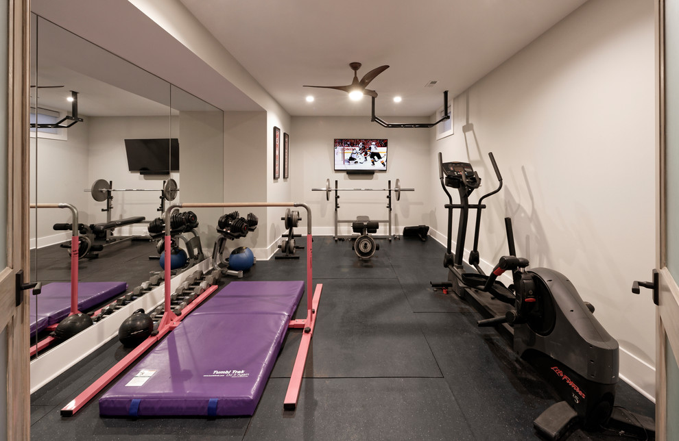 Design ideas for a large transitional home gym in DC Metro with white walls, black floor and laminate floors.