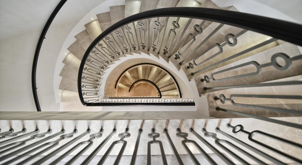 Mid-sized contemporary metal spiral staircase in London with metal risers.