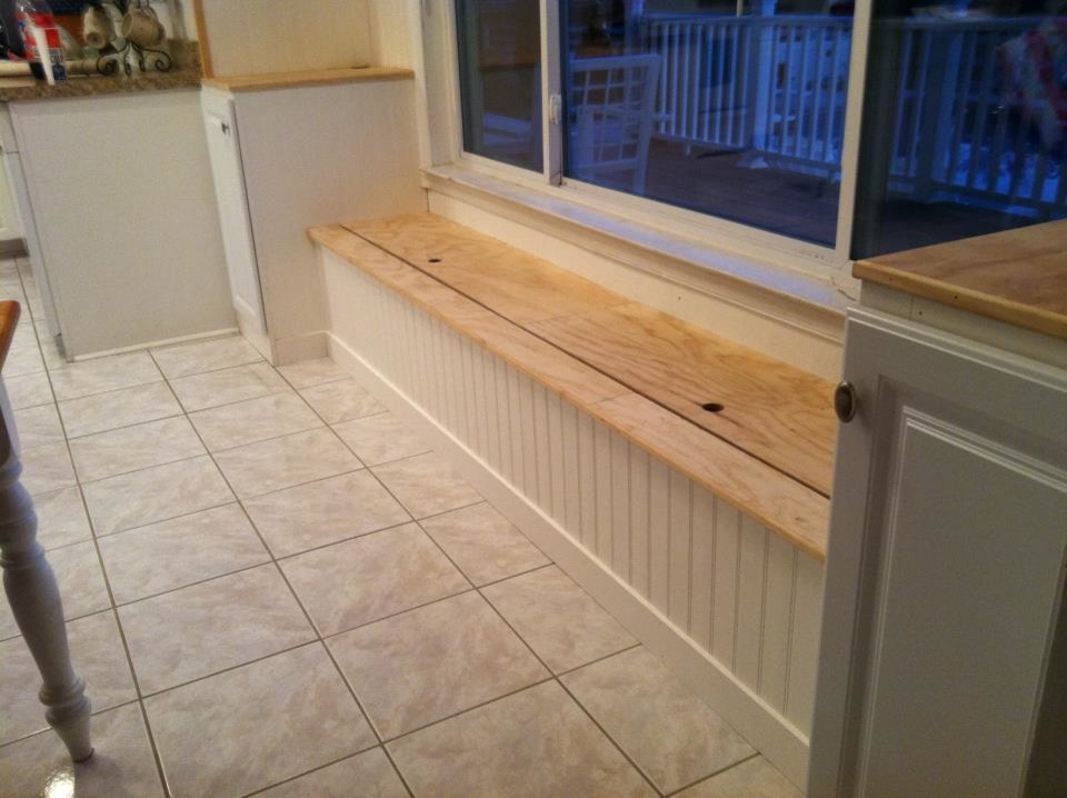 Kitchen - mid-sized ceramic tile kitchen idea with white cabinets and wood countertops