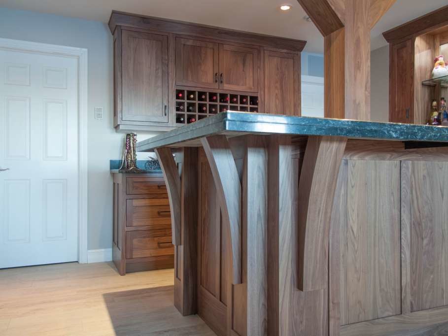 Home design - mid-sized transitional l-shaped light wood floor and beige floor home design idea with an integrated sink, shaker cabinets, medium tone wood cabinets and granite countertops