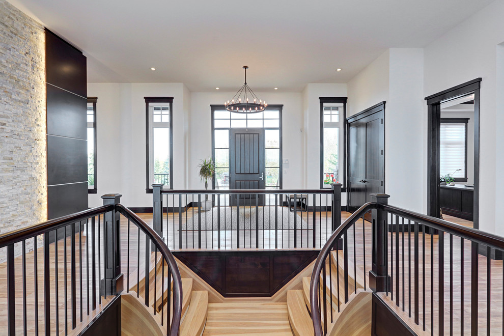 Example of a large transitional porcelain tile front door design in Calgary with white walls and a dark wood front door