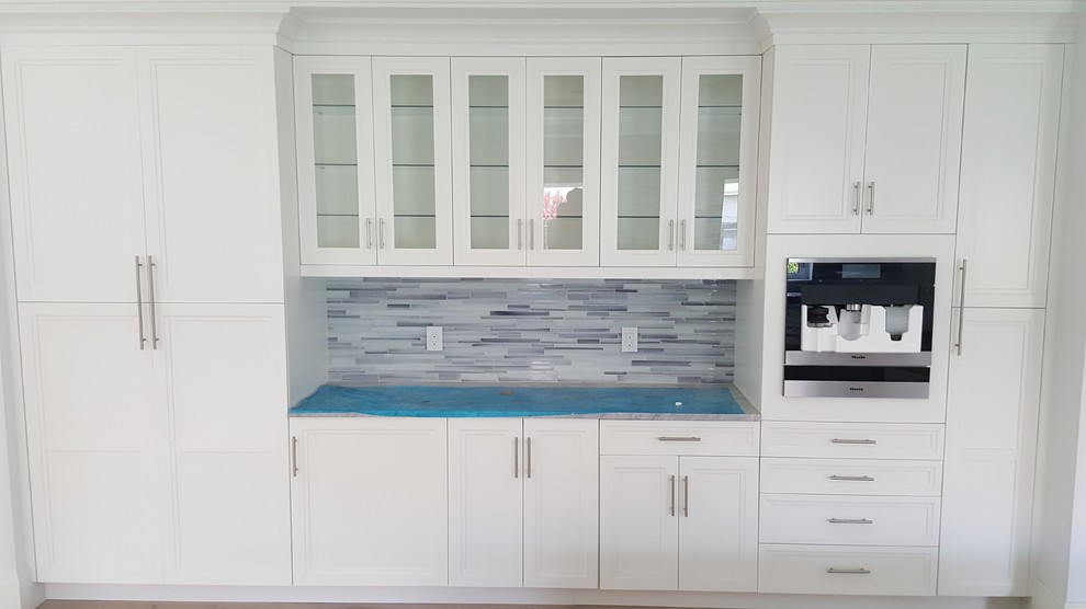 Example of a transitional kitchen design in Miami with shaker cabinets and white cabinets
