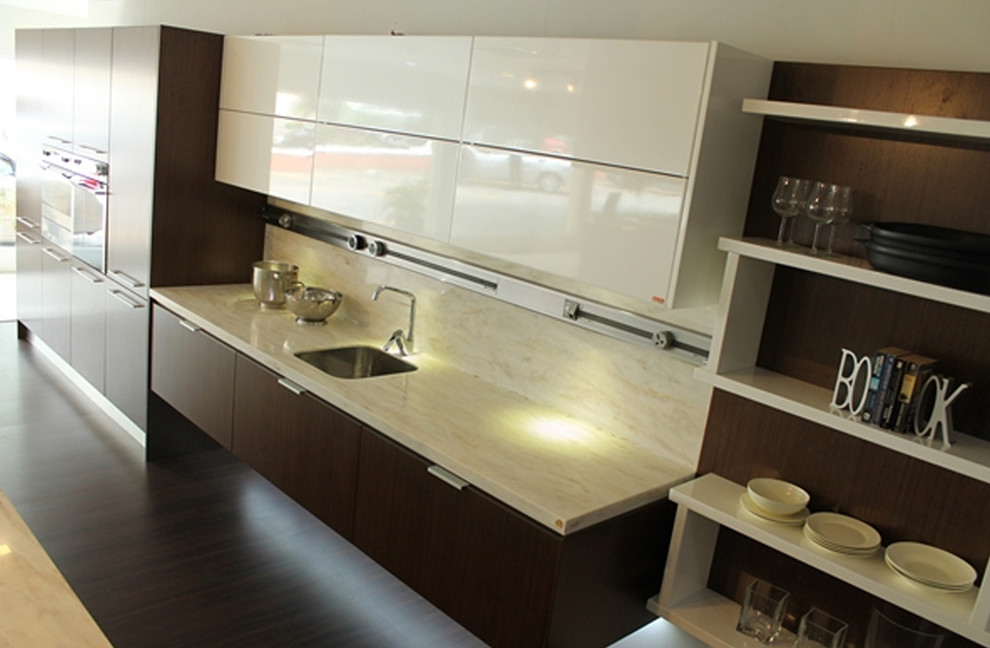 Photo of a large modern galley open plan kitchen in Other with a drop-in sink, flat-panel cabinets, medium wood cabinets, solid surface benchtops and with island.