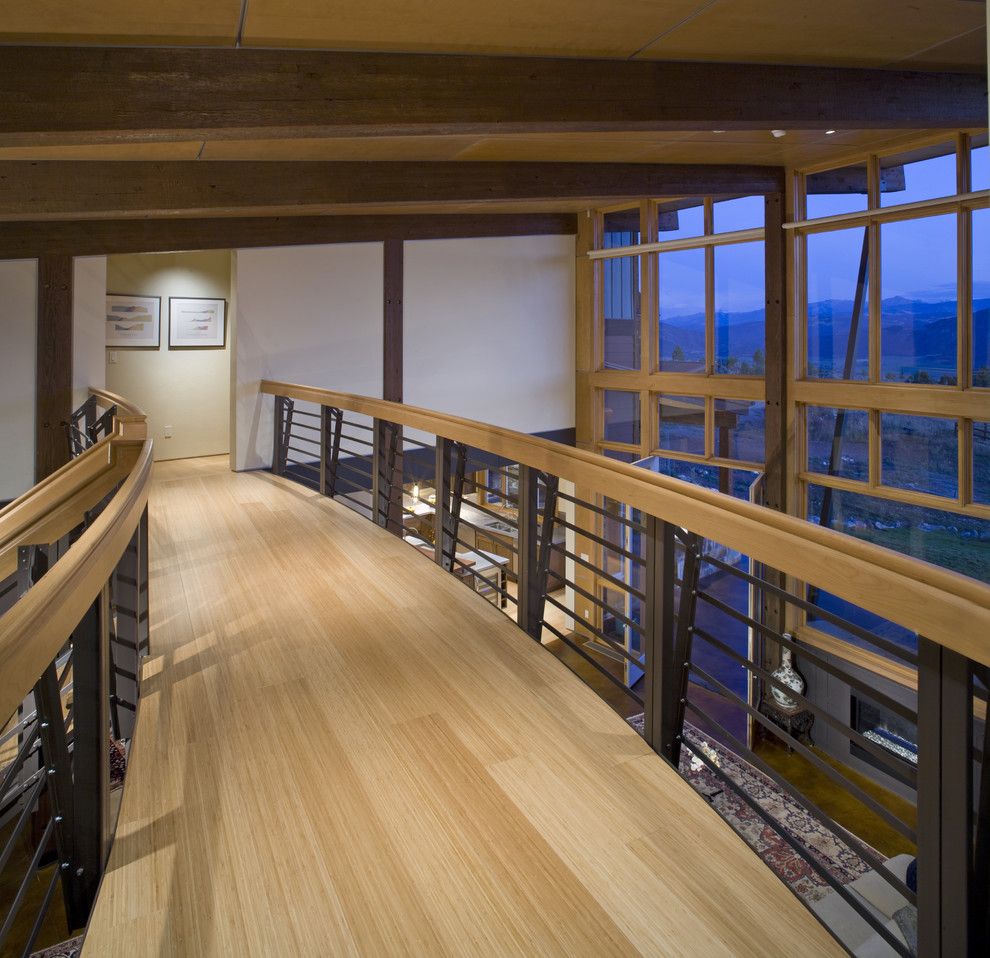 Photo of a contemporary hallway in Denver with light hardwood floors.