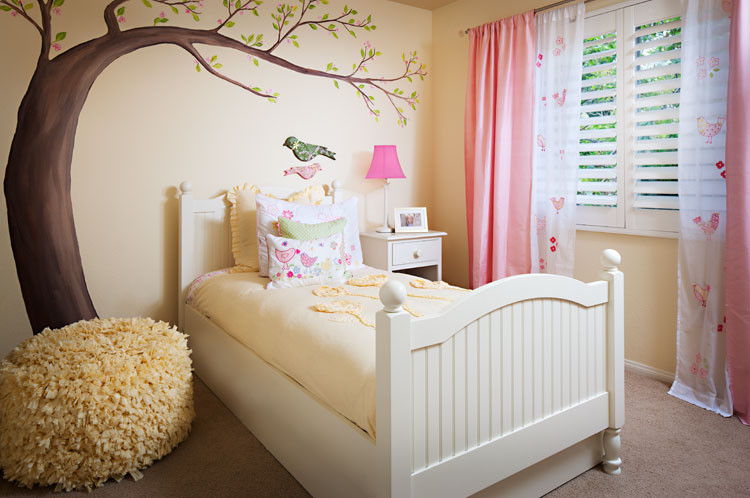 Design ideas for a mid-sized traditional kids' bedroom for kids 4-10 years old and girls in San Diego with yellow walls and carpet.