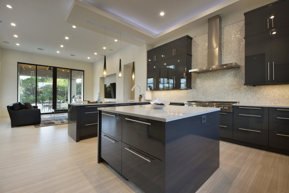 This is an example of a contemporary kitchen in Austin with stainless steel appliances and with island.