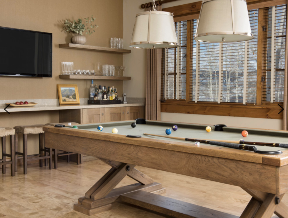 Photo of a mid-sized transitional open concept family room in Denver with a game room, beige walls, light hardwood floors, a wall-mounted tv and beige floor.
