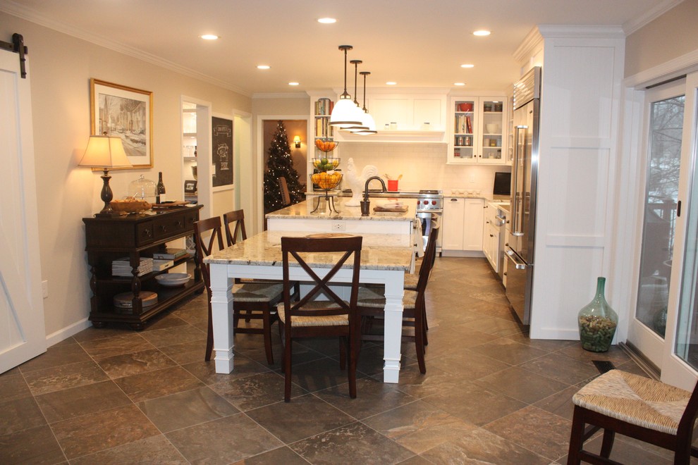 Example of a large transitional u-shaped eat-in kitchen design with shaker cabinets, white cabinets, white backsplash, stainless steel appliances and an island