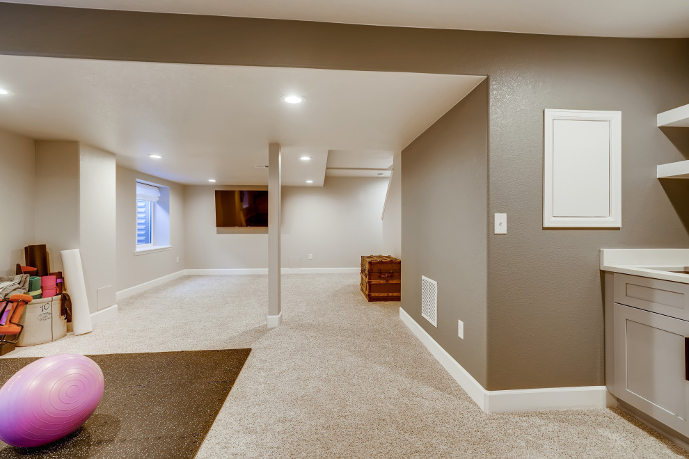 Mid-sized trendy underground carpeted and wallpaper basement photo in Denver with gray walls