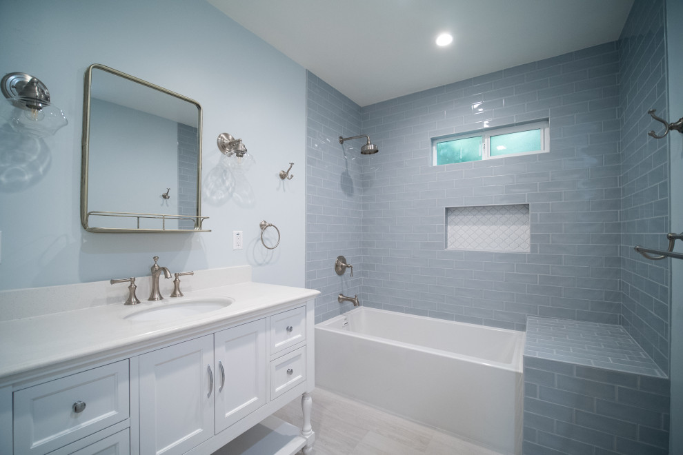 Small master bathroom in Los Angeles with furniture-like cabinets, white cabinets, an undermount tub, a shower/bathtub combo, a one-piece toilet, gray tile, subway tile, grey walls, porcelain floors, an undermount sink, quartzite benchtops, grey floor, a shower curtain, white benchtops, a single vanity and a freestanding vanity.