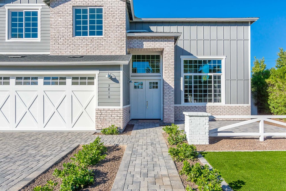 Example of a transitional front door design in Phoenix with gray walls and a white front door