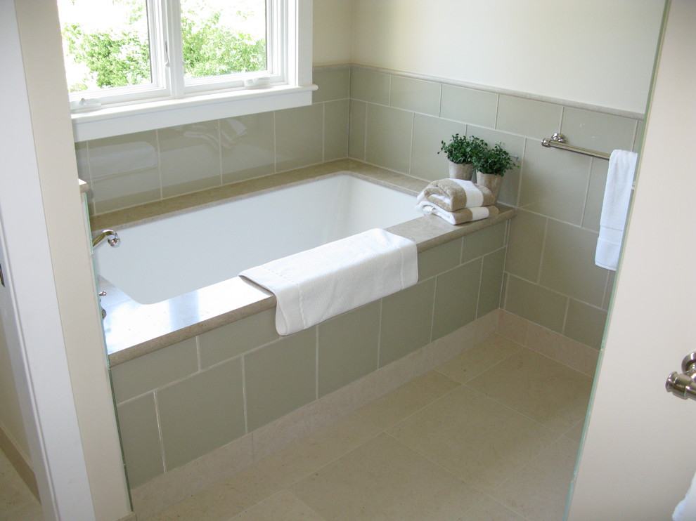 Mid-sized contemporary 3/4 bathroom in San Francisco with recessed-panel cabinets, white cabinets, an alcove shower, a two-piece toilet, beige tile, stone tile, beige walls, limestone floors, an undermount sink, limestone benchtops, beige floor, a hinged shower door and an alcove tub.