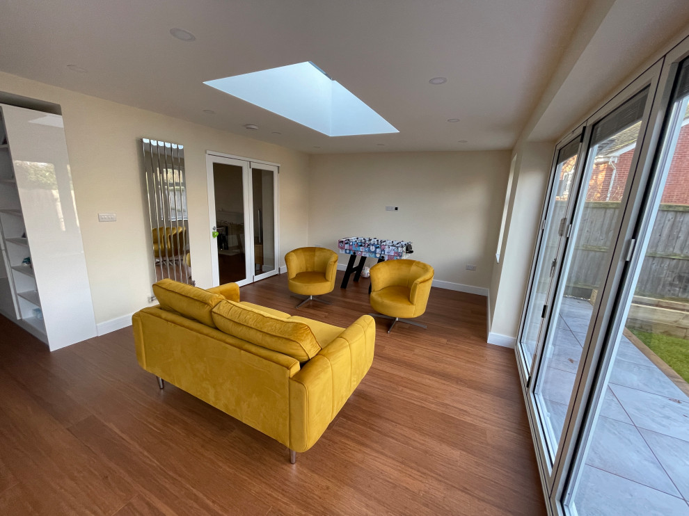 Photo of a medium sized contemporary open plan games room in Other with a game room, laminate floors, no fireplace and no tv.