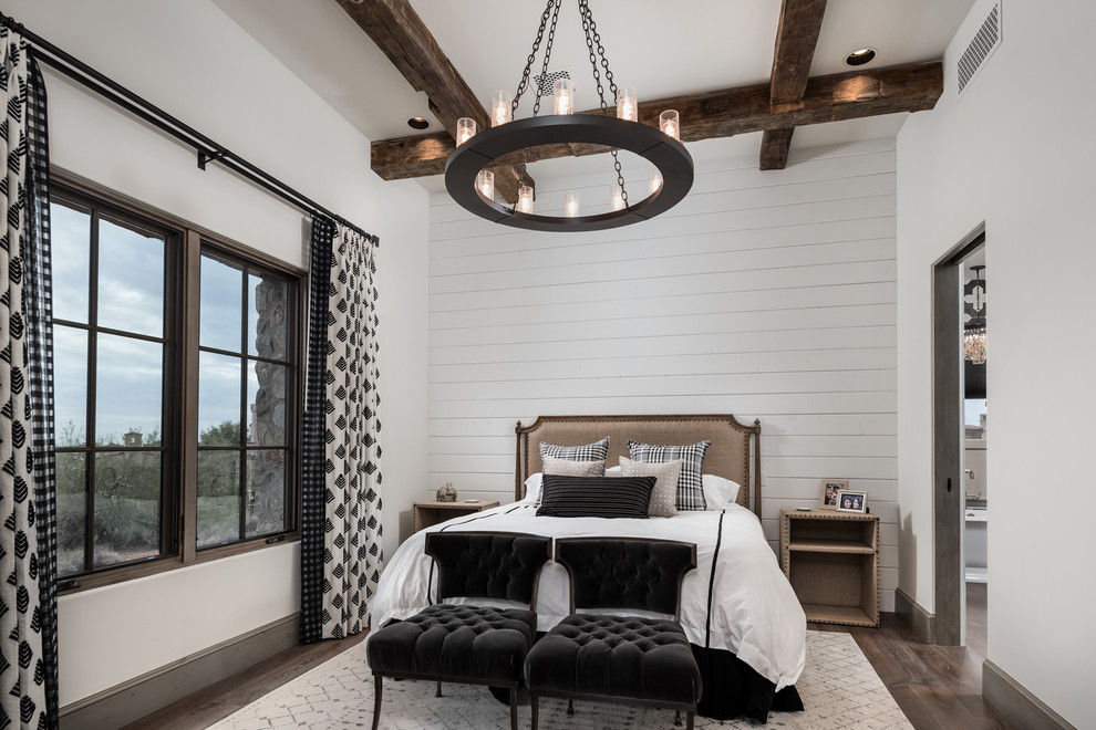 Design ideas for an expansive country master bedroom in Phoenix with white walls, dark hardwood floors, a two-sided fireplace, a stone fireplace surround, brown floor, exposed beam and planked wall panelling.