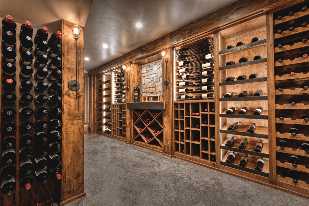 Mid-sized tuscan concrete floor and gray floor wine cellar photo in Portland with diamond bins