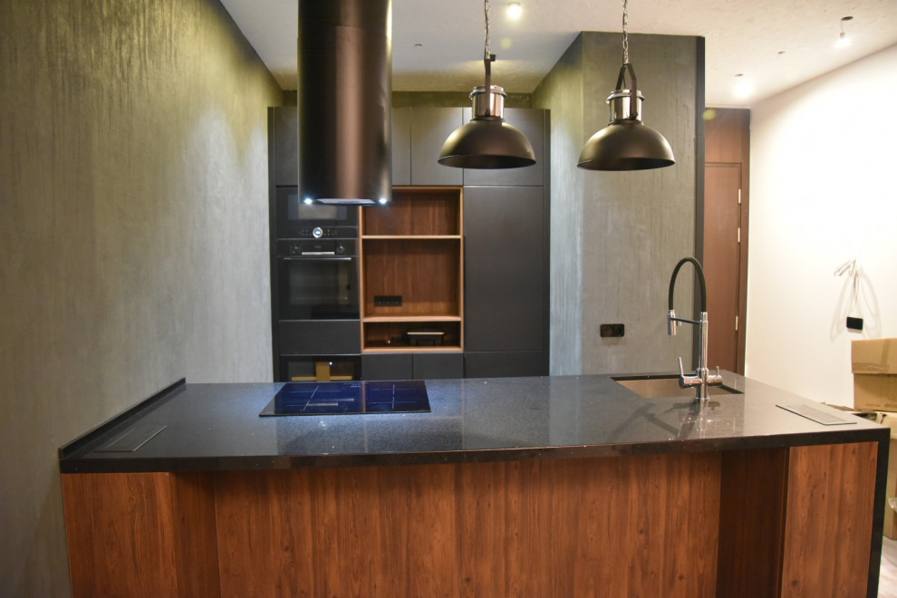 Photo of a medium sized contemporary single-wall kitchen/diner in Moscow with a submerged sink, flat-panel cabinets, black cabinets, composite countertops, black appliances, porcelain flooring, an island, multi-coloured floors, black worktops and all types of ceiling.