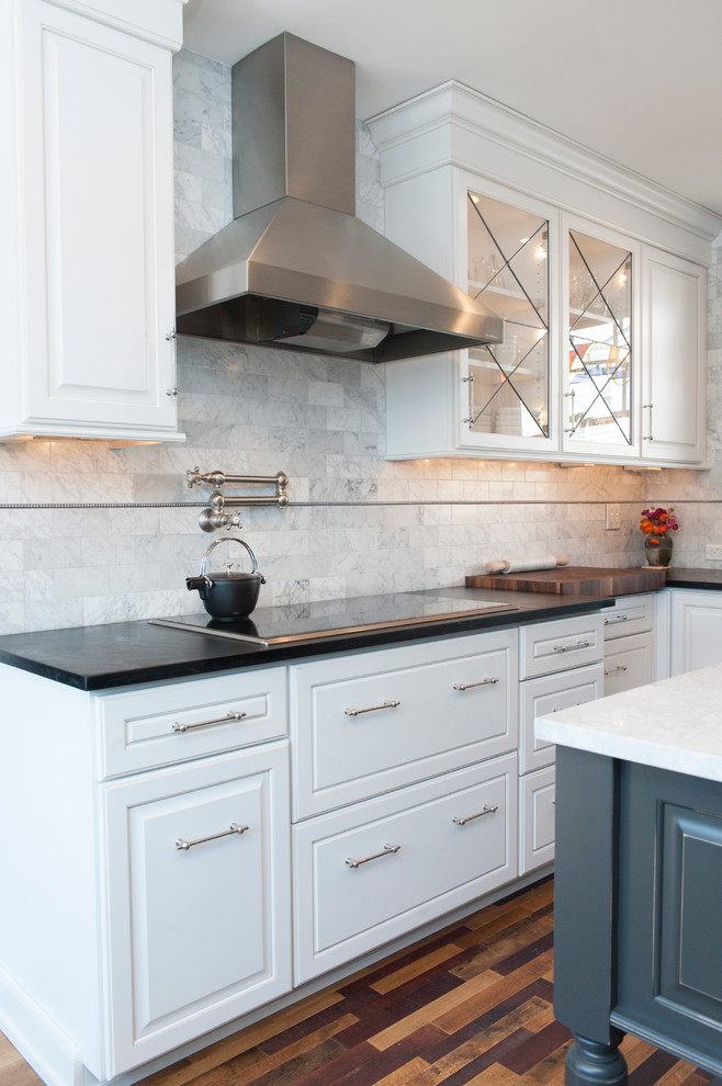 Inspiration for a small traditional l-shaped separate kitchen in Philadelphia with a farmhouse sink, white cabinets, soapstone benchtops, panelled appliances, medium hardwood floors, with island, multi-coloured floor and black benchtop.