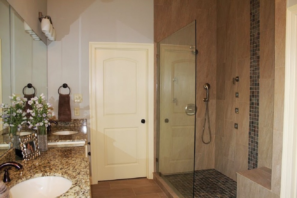 Mid-sized transitional master bathroom in New Orleans with an undermount sink, raised-panel cabinets, beige cabinets, granite benchtops, an alcove tub, an open shower, a two-piece toilet, brown tile, porcelain tile, grey walls and porcelain floors.