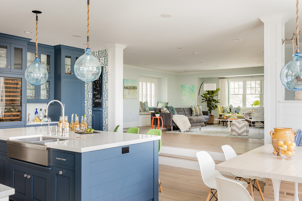 Open concept kitchen - coastal light wood floor open concept kitchen idea in Boston with white backsplash and white countertops