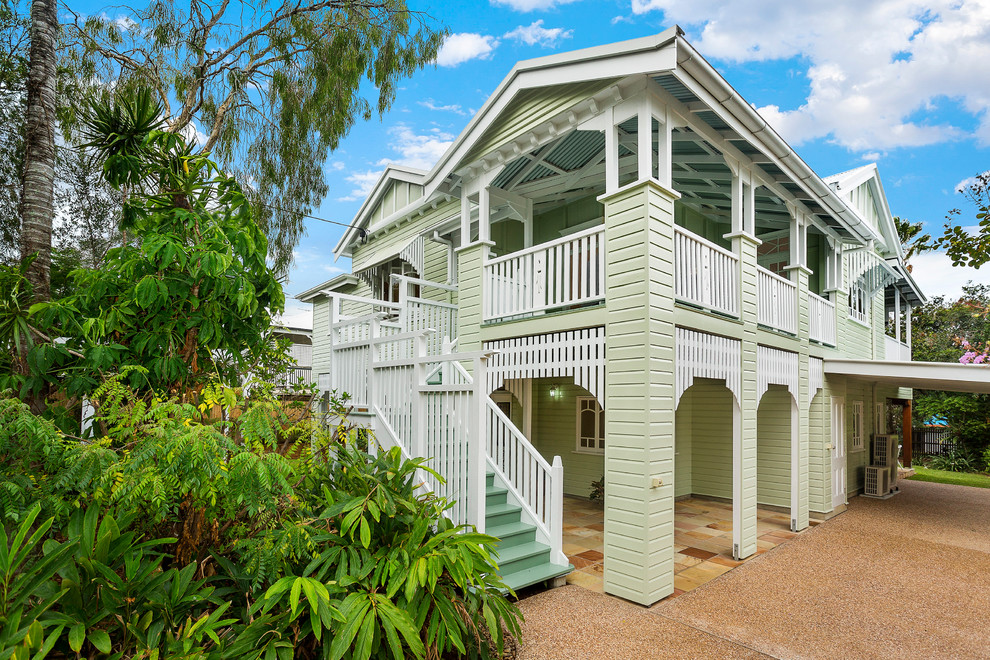 Inspiration for a traditional two-storey green exterior in Brisbane with wood siding and a gable roof.