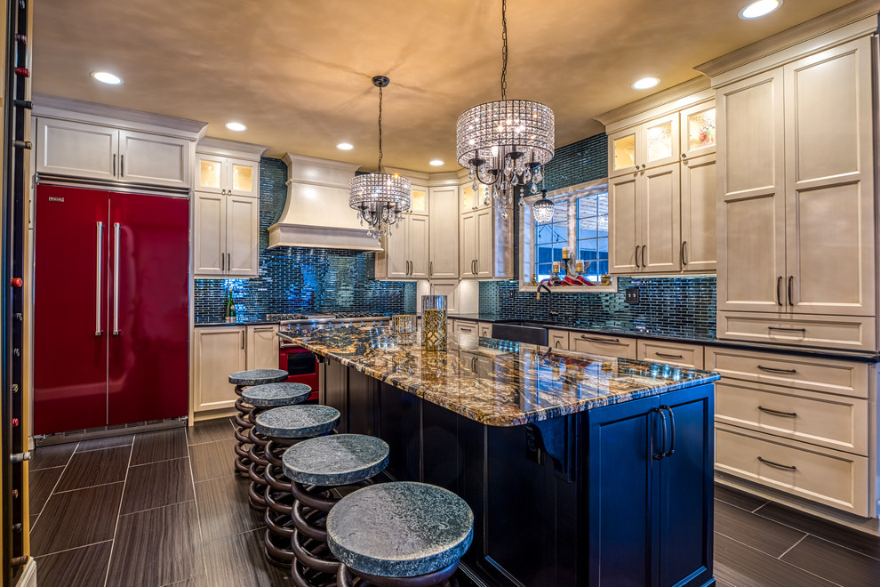 Large eclectic l-shaped separate kitchen in Philadelphia with a farmhouse sink, recessed-panel cabinets, white cabinets, granite benchtops, blue splashback, glass tile splashback, coloured appliances, porcelain floors, with island, black floor and black benchtop.