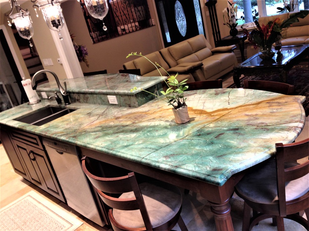 Mid-sized transitional travertine floor and beige floor eat-in kitchen photo in Chicago with a double-bowl sink, raised-panel cabinets, dark wood cabinets, quartzite countertops, beige backsplash, stone tile backsplash, stainless steel appliances and an island