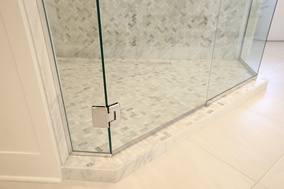 Mid-sized transitional master porcelain tile and white floor freestanding bathtub photo with an undermount sink and a hinged shower door