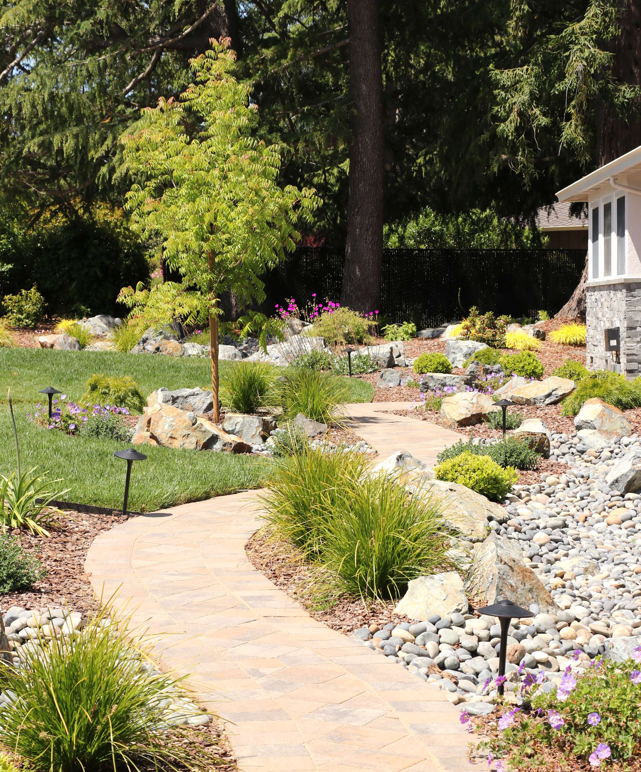 FRONT YARD WITH TREES AND DRY-CREEK