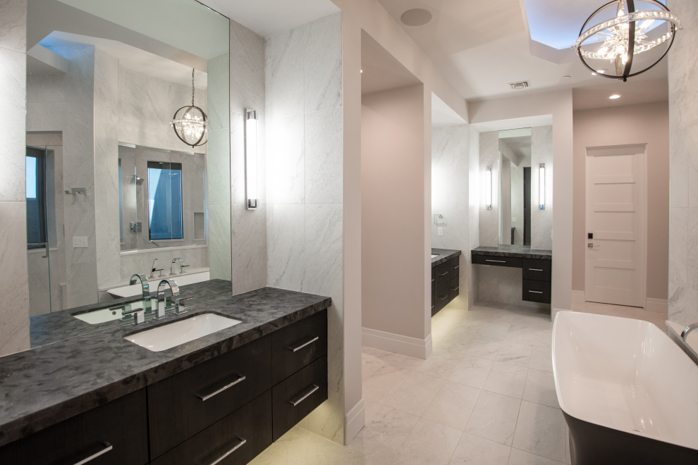 Example of a large minimalist master white tile and slate tile slate floor, white floor, double-sink and tray ceiling bathroom design in Phoenix with flat-panel cabinets, black cabinets, a one-piece toilet, white walls, a drop-in sink, granite countertops, multicolored countertops and a floating vanity