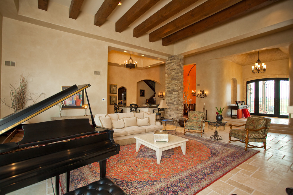 Photo of a large mediterranean open concept family room in Chicago with beige walls, limestone floors, a standard fireplace, a stone fireplace surround and no tv.