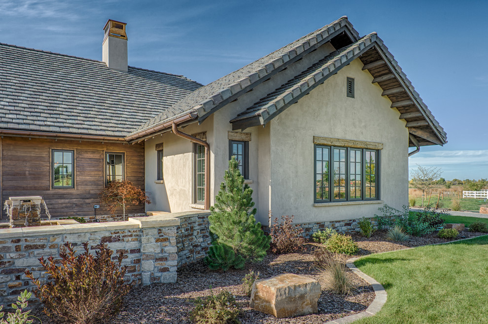Large country one-storey adobe beige exterior in Denver.