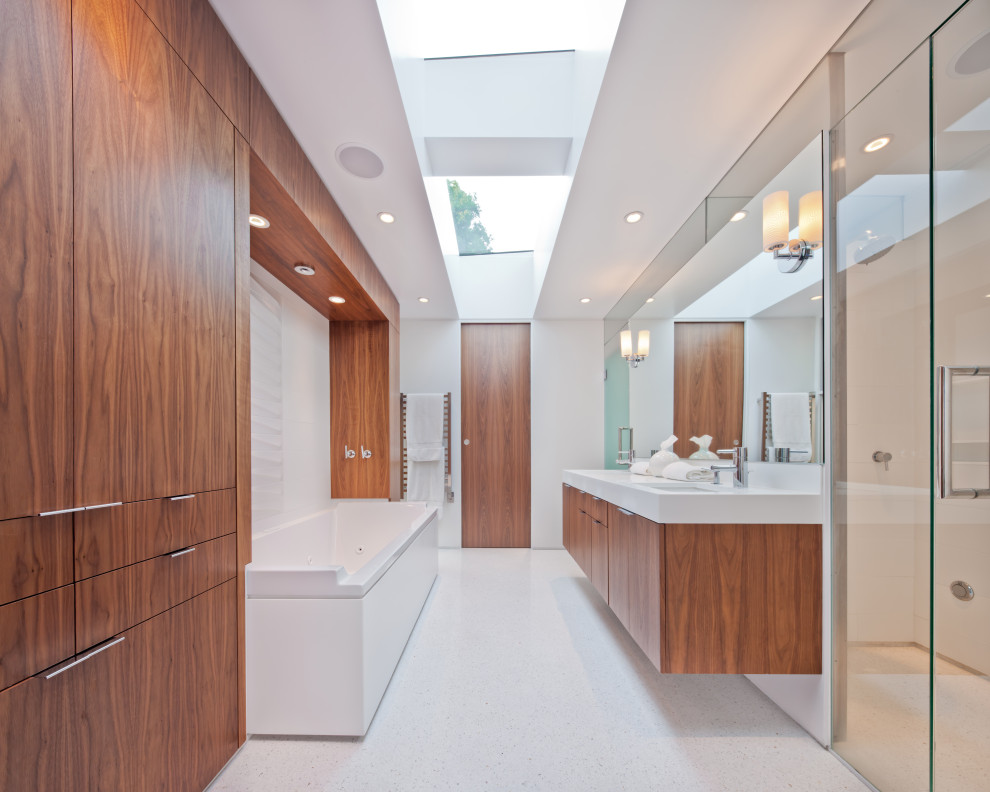 Photo of a large midcentury master bathroom in Minneapolis with flat-panel cabinets, medium wood cabinets, an alcove tub, an alcove shower, white walls, an undermount sink, white floor, a hinged shower door and white benchtops.