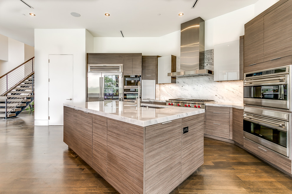 This is an example of a modern kitchen in Dallas with marble benchtops and stainless steel appliances.