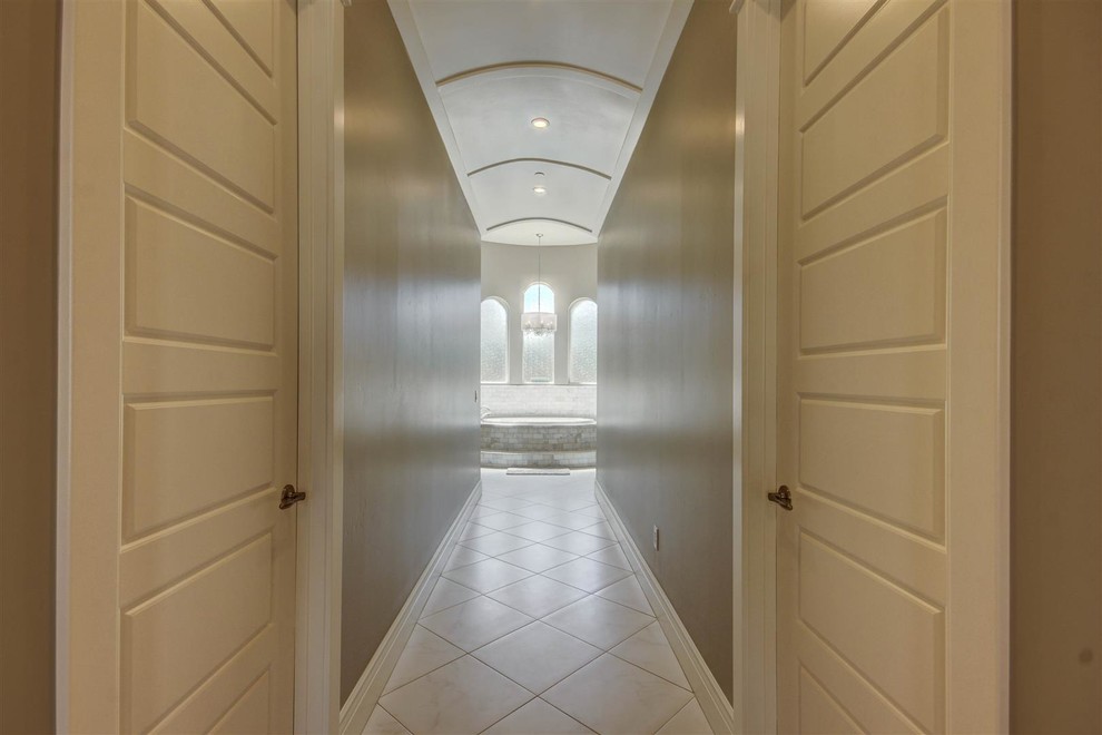 Example of a large transitional ceramic tile hallway design in Phoenix with gray walls