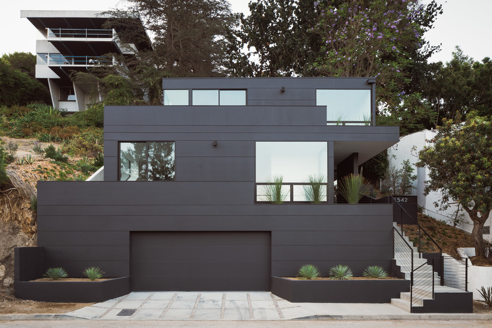 Design ideas for a mid-sized contemporary three-storey black house exterior in Los Angeles with concrete fiberboard siding, a flat roof and a green roof.