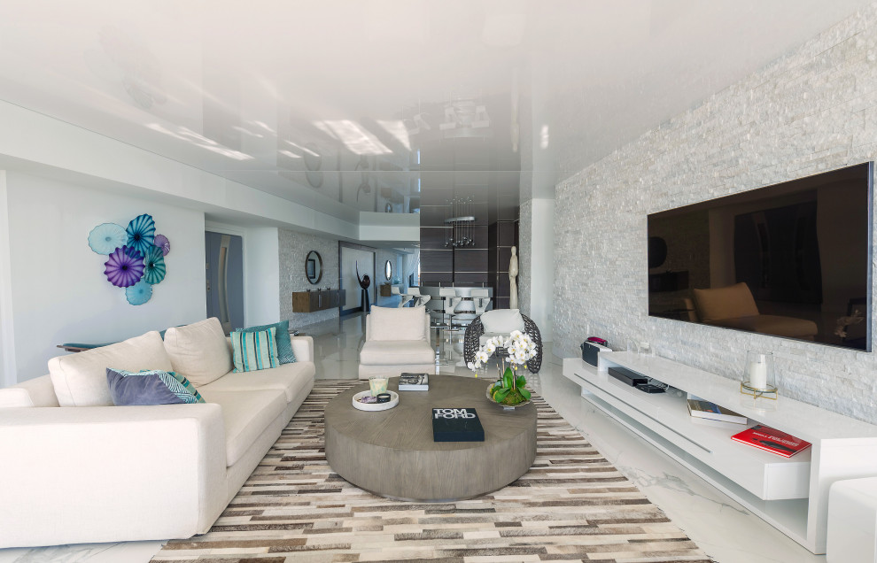 Inspiration for a large contemporary open concept living room in Miami with white walls, marble floors, a wall-mounted tv, white floor and wallpaper.