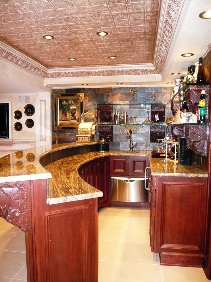 This is an example of a mid-sized country u-shaped seated home bar in New York with an undermount sink, dark wood cabinets, granite benchtops, multi-coloured splashback, porcelain floors and slate splashback.