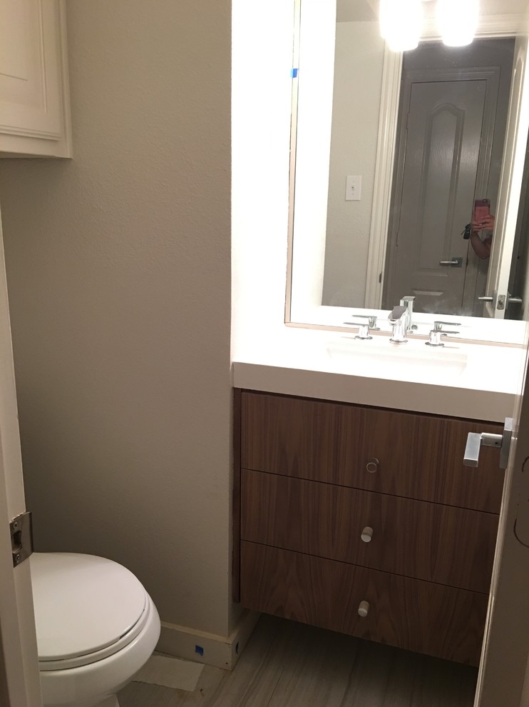 Transitional porcelain tile home design photo in Dallas with medium tone wood cabinets, an undermount sink and quartz countertops