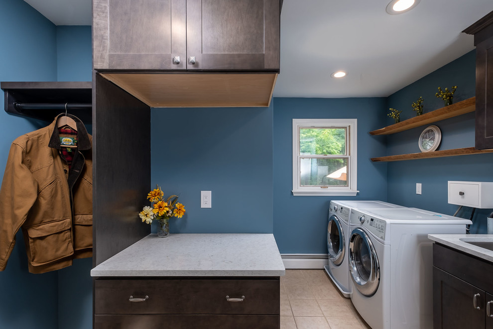 This is an example of a small country utility room in Philadelphia with an undermount sink, recessed-panel cabinets, brown cabinets, quartz benchtops, blue walls, a side-by-side washer and dryer and multi-coloured benchtop.