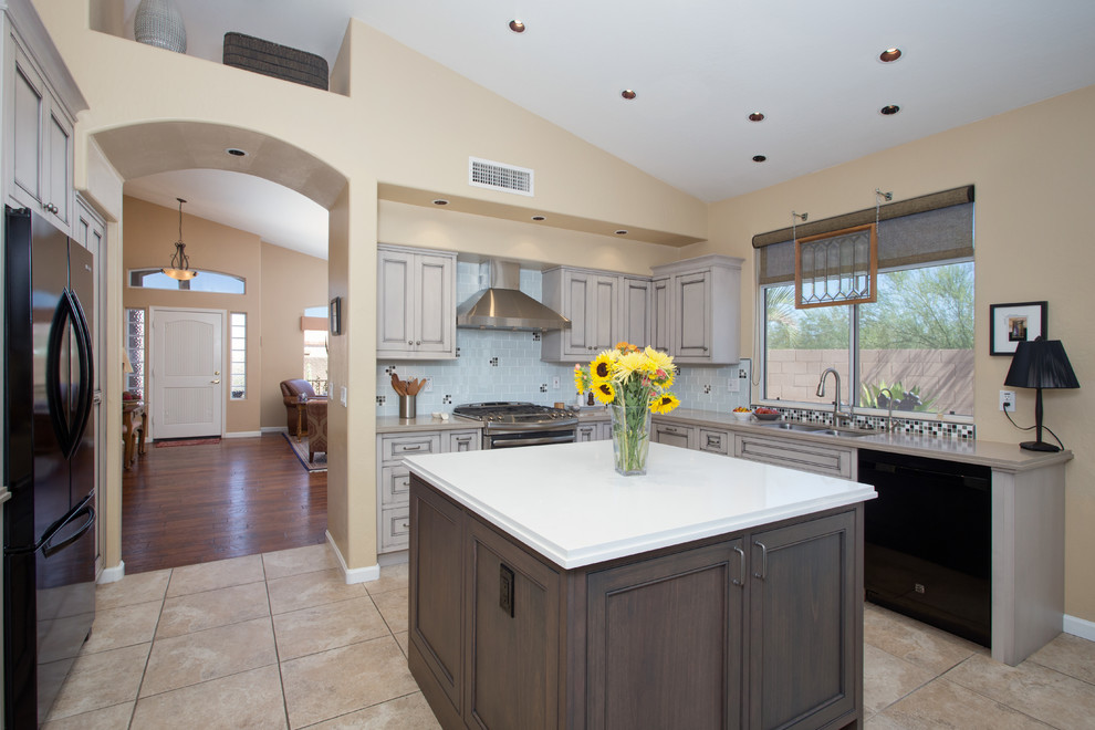 Open concept kitchen - large transitional l-shaped ceramic tile open concept kitchen idea in Phoenix with an undermount sink, beaded inset cabinets, gray cabinets, quartz countertops, white backsplash, glass tile backsplash, black appliances and an island