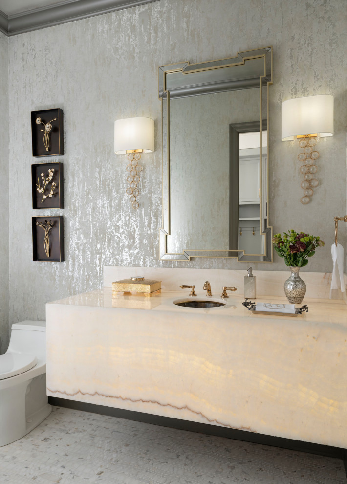 Example of a mid-sized transitional marble floor, white floor and wallpaper powder room design in Dallas with beige cabinets, an undermount sink, onyx countertops, beige countertops and a floating vanity