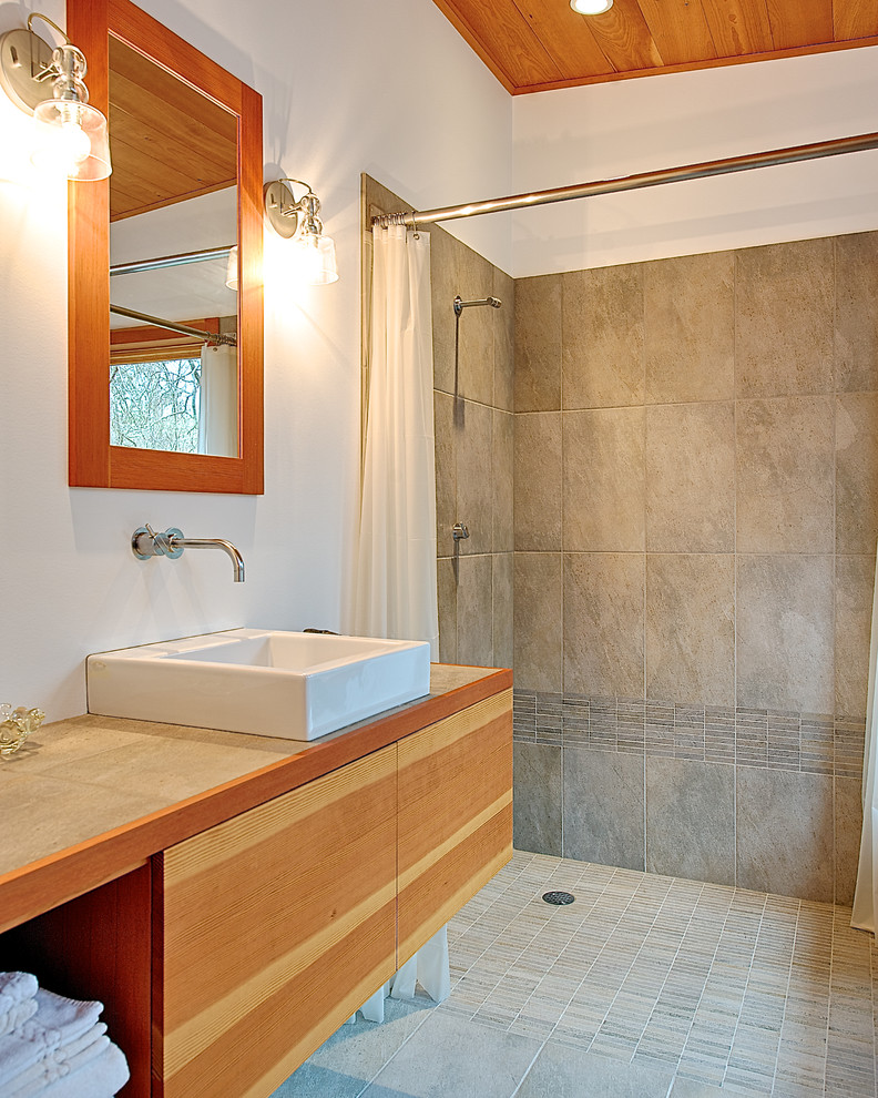 Photo of a small contemporary master bathroom in Seattle with a vessel sink, flat-panel cabinets, light wood cabinets, white walls, ceramic floors, an open shower, gray tile, ceramic tile, tile benchtops, grey floor, a shower curtain and grey benchtops.
