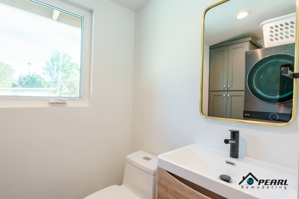 Photo of a small modern cloakroom in Los Angeles with flat-panel cabinets, light wood cabinets, a two-piece toilet, white tiles, white walls, ceramic flooring, a built-in sink, engineered stone worktops, grey floors, white worktops and a floating vanity unit.