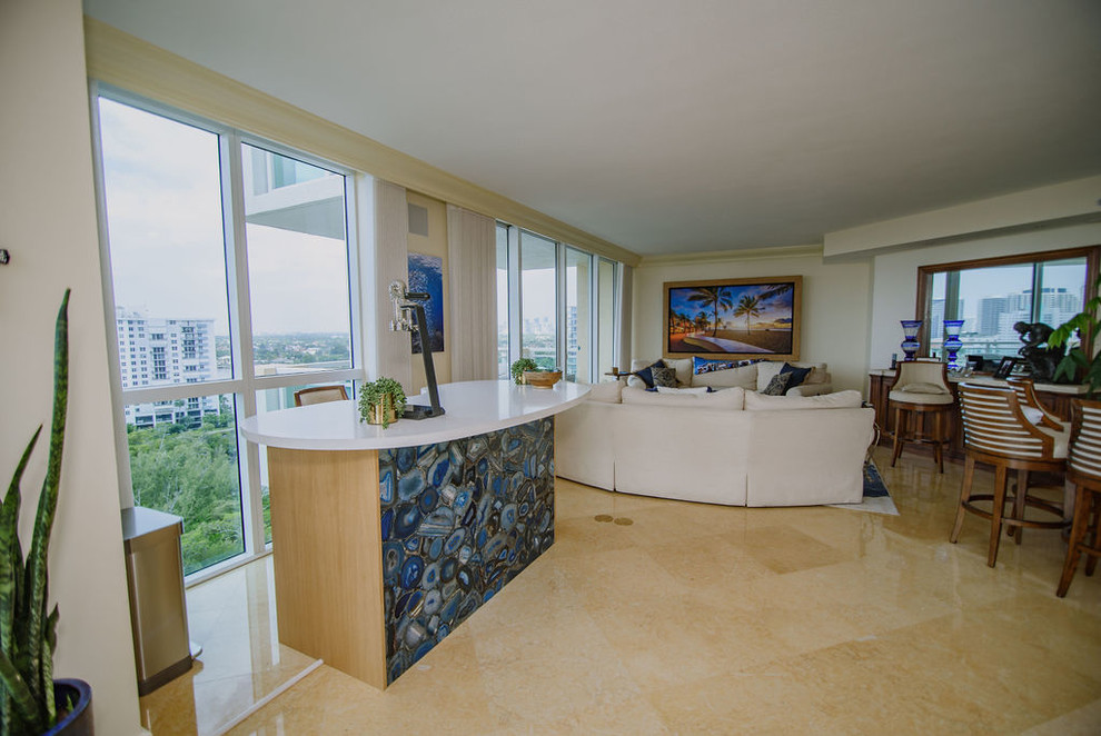 Mid-sized transitional u-shaped porcelain tile and beige floor open concept kitchen photo in Miami with an undermount sink, flat-panel cabinets, light wood cabinets, quartz countertops, white backsplash, stainless steel appliances, an island and white countertops