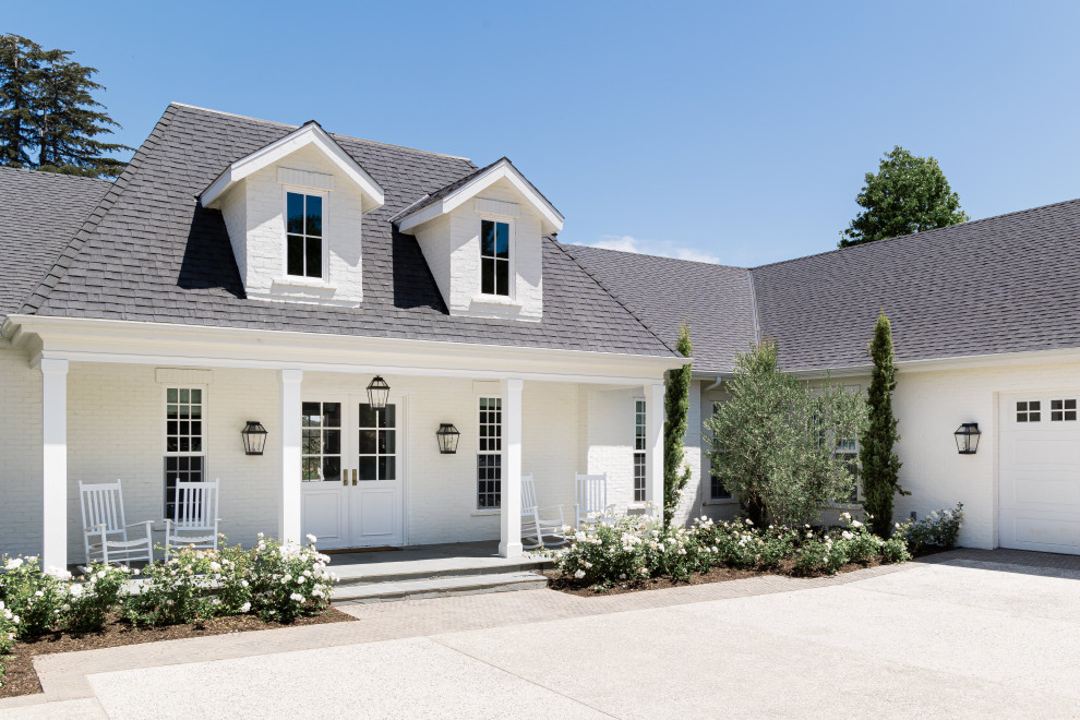 Inspiration for a farmhouse white two-story brick house exterior remodel in San Diego with a hip roof, a shingle roof and a gray roof