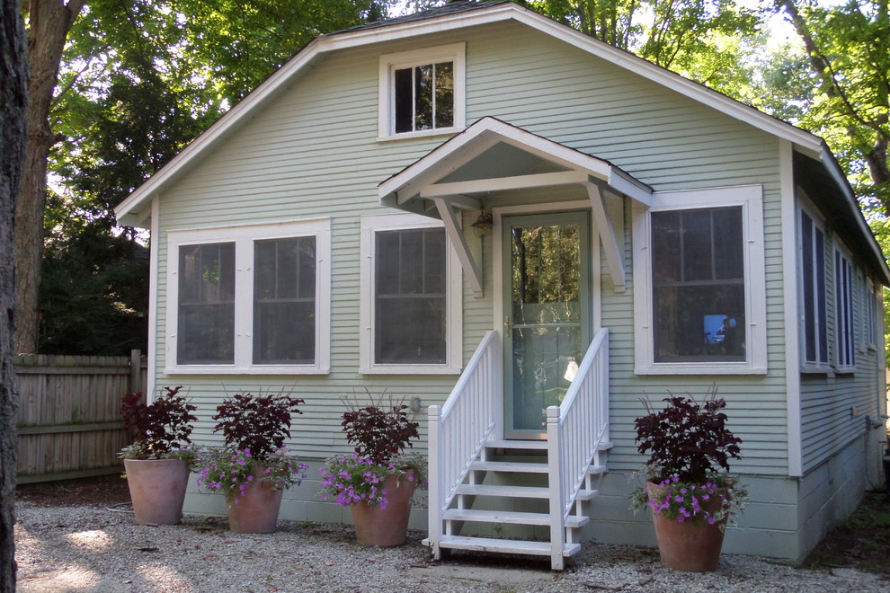 Small traditional one-storey green exterior in Chicago with wood siding and a shed roof.
