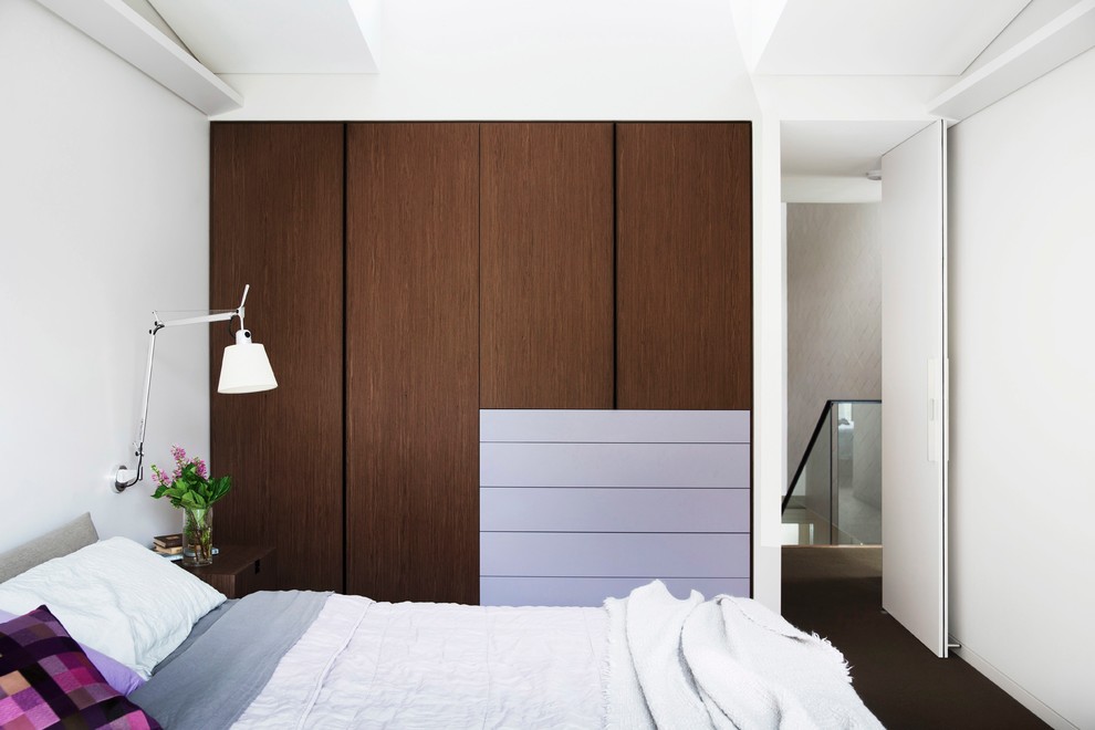 Mid-sized contemporary master bedroom in Sydney with beige walls and carpet.
