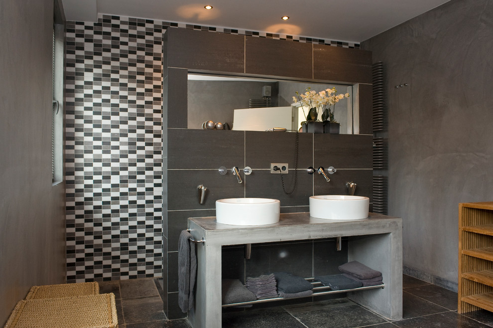 This is an example of an industrial master bathroom in Amsterdam with an open shower, black and white tile, gray tile, grey walls, a vessel sink and an open shower.